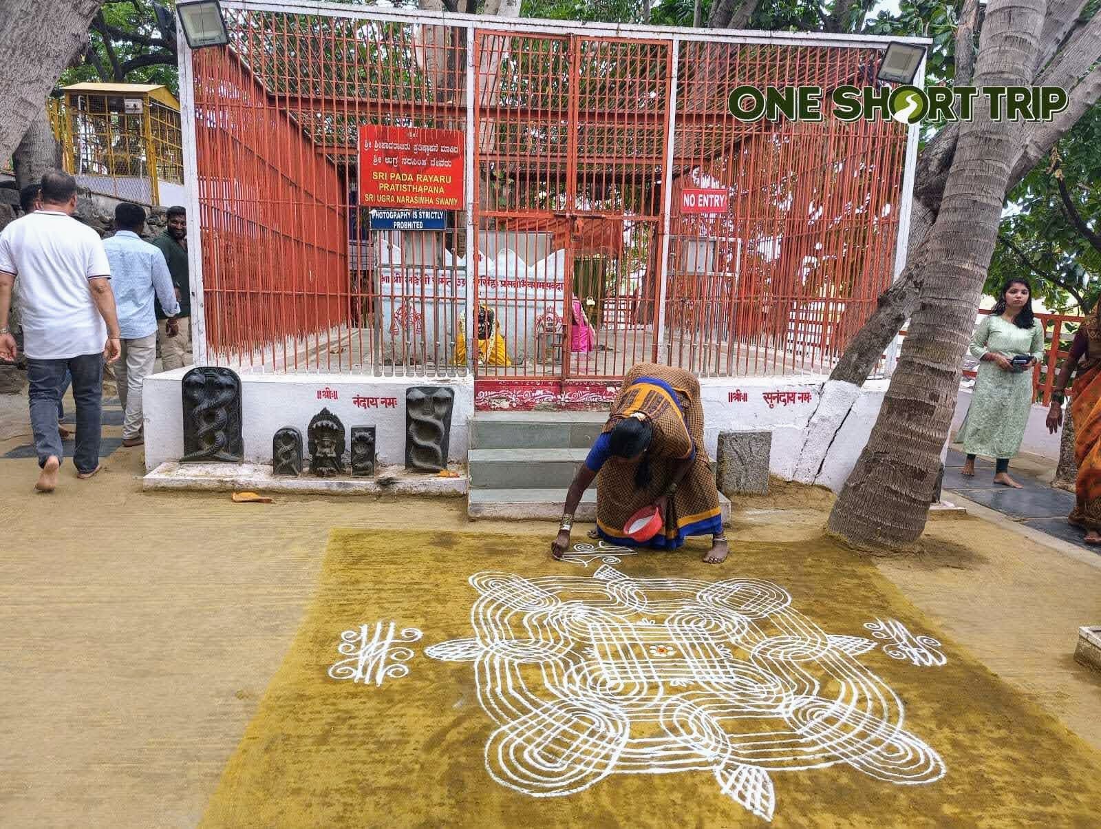 Bichale Sri Raghavendra Teerthara Brundavana 3 Devotee drawing a rangoli outside the Brundavana gate at Bichale